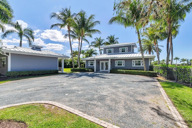 13408 55th St S, Wellington, FL 33449 - view of front of property with metal roof, gravel driveway, a standing seam roof, and french doors