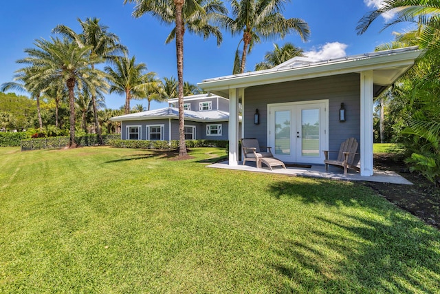 13408 55th St S, Wellington, FL 33449 - back of property with french doors, a patio, and a lawn