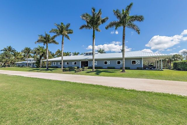 13408 55th St S, Wellington, FL 33449 - view of front of property with an attached carport, a front yard, metal roof, and driveway