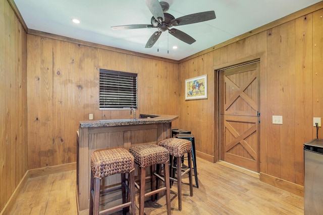 13408 55th St S, Wellington, FL 33449 - bar with light wood-style flooring, wood walls, and bar