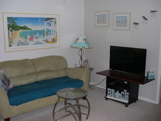 carpeted living area featuring baseboards