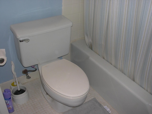 full bathroom featuring tile patterned flooring and toilet