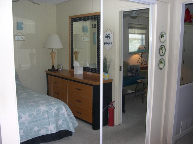 carpeted bedroom featuring visible vents