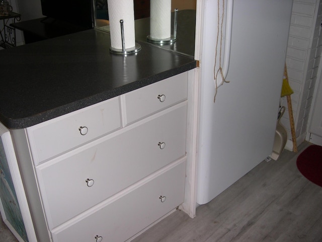 room details featuring wood finished floors and freestanding refrigerator