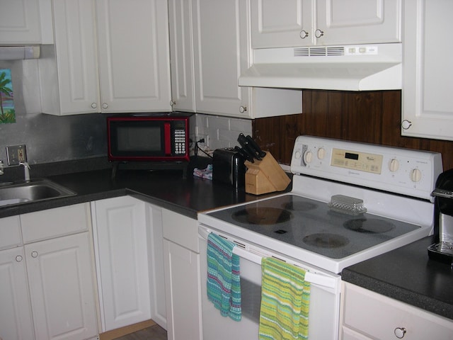 kitchen with under cabinet range hood, white electric range, a sink, backsplash, and white cabinetry