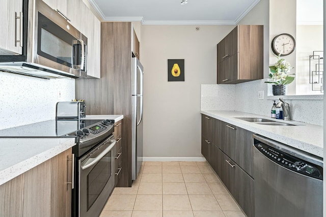 kitchen with tasteful backsplash, stainless steel appliances, crown molding, and a sink