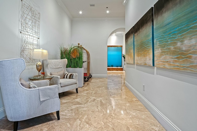 sitting room featuring visible vents, baseboards, ornamental molding, arched walkways, and marble finish floor