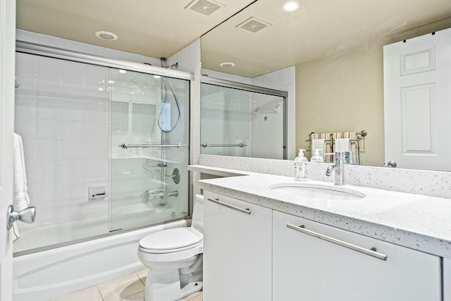 full bathroom featuring tile patterned flooring, visible vents, toilet, and enclosed tub / shower combo