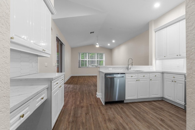 kitchen featuring white cabinets, dishwasher, lofted ceiling, and a sink