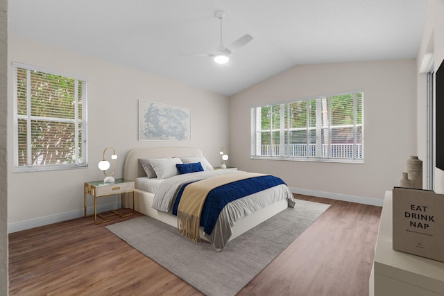 bedroom featuring baseboards, a ceiling fan, lofted ceiling, and wood finished floors