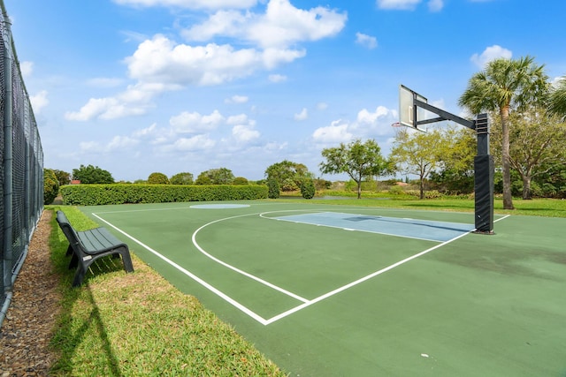 view of basketball court with community basketball court and fence