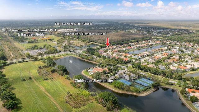 birds eye view of property with a water view