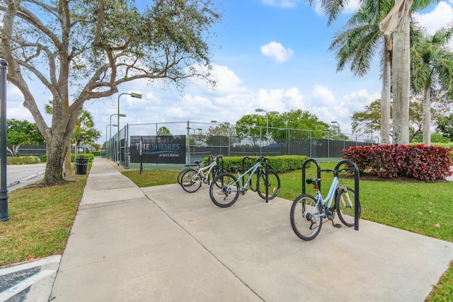 surrounding community with a lawn and fence