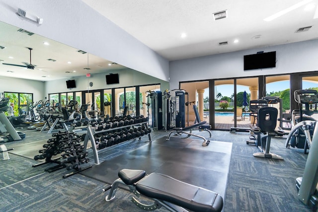 exercise room featuring visible vents and ceiling fan