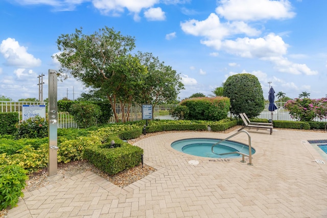 view of pool with a hot tub, a patio, and fence