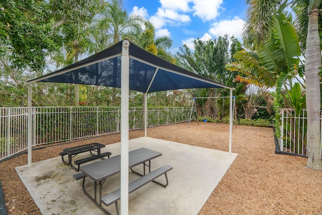 view of patio / terrace with playground community and a fenced backyard