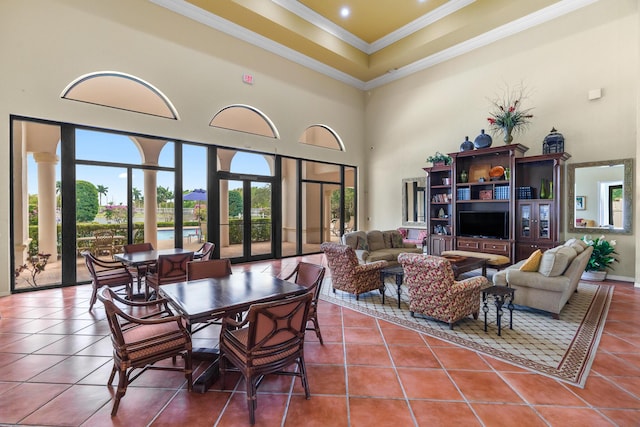 tiled dining room with a high ceiling and ornamental molding