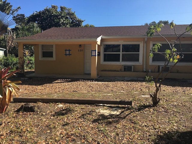 view of front of home featuring stucco siding and a shingled roof