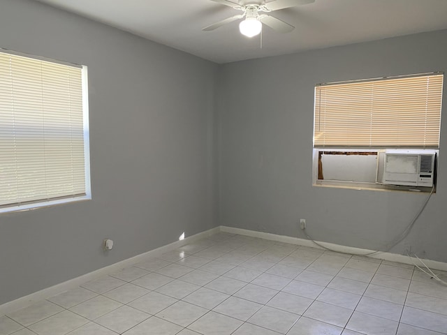 spare room with baseboards and a ceiling fan