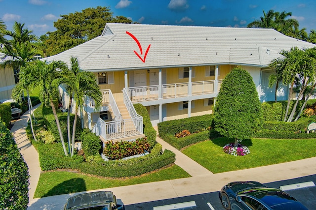 1 Church Ln Unit 111, North Palm Beach, FL 33408 - view of property featuring uncovered parking and stairway