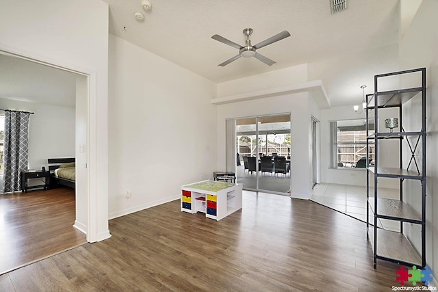 unfurnished room featuring visible vents, baseboards, a ceiling fan, and wood finished floors