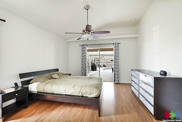 bedroom featuring a ceiling fan, vaulted ceiling, access to outside, and wood finished floors