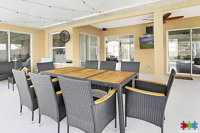 view of patio with outdoor dining space and a ceiling fan