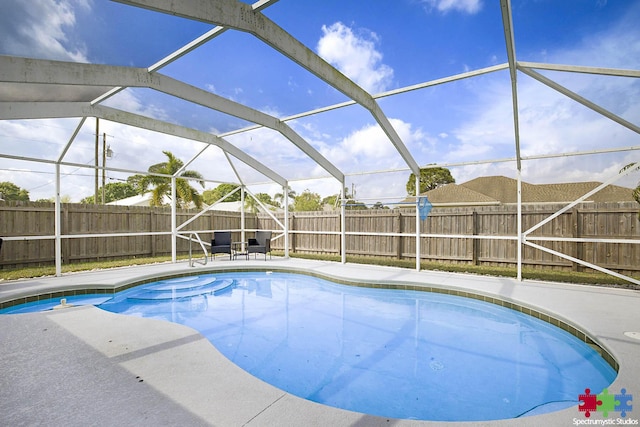 view of swimming pool featuring a lanai, a fenced in pool, a patio, and a fenced backyard