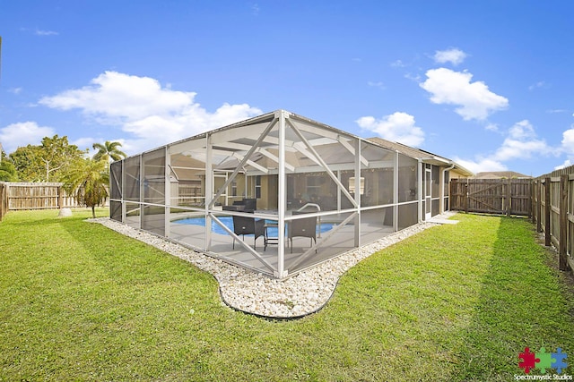 view of swimming pool with a fenced in pool, a lawn, glass enclosure, a fenced backyard, and a patio area