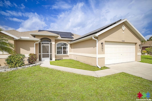 view of front facade featuring stucco siding, concrete driveway, a front yard, a garage, and solar panels