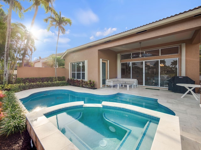 view of pool featuring fence, an in ground hot tub, a ceiling fan, and a patio area