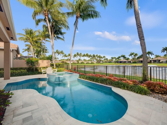 view of swimming pool with a patio area, a pool with connected hot tub, a fenced backyard, and a water view