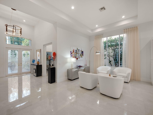 living area featuring visible vents, recessed lighting, baseboards, french doors, and a raised ceiling