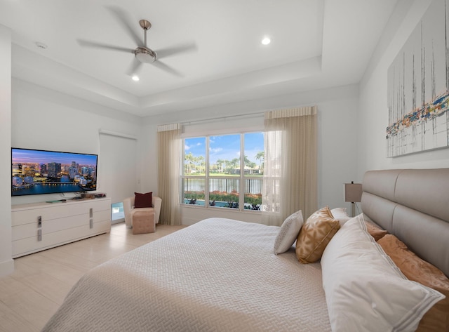 bedroom featuring recessed lighting, a ceiling fan, and a tray ceiling