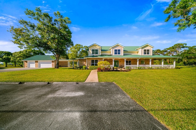 view of front of home with aphalt driveway, an attached garage, a porch, and a front yard