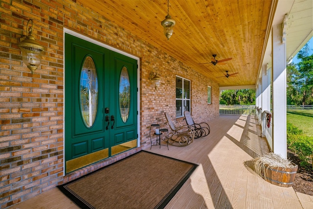 8686 Andrews Ave, Fort Pierce, FL 34945 - doorway to property featuring a porch, brick siding, and ceiling fan