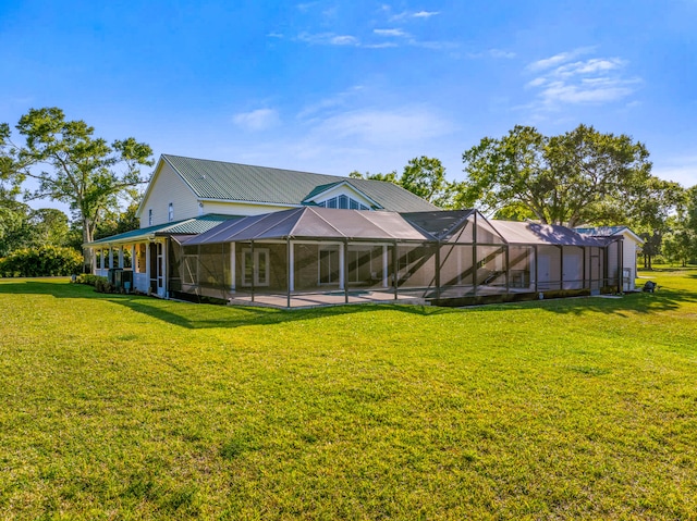 8686 Andrews Ave, Fort Pierce, FL 34945 - back of house with a lawn, a patio area, a lanai, and metal roof