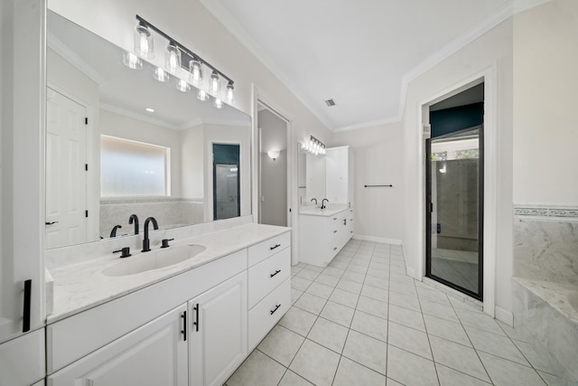 full bathroom with a sink, two vanities, ornamental molding, and tile patterned flooring