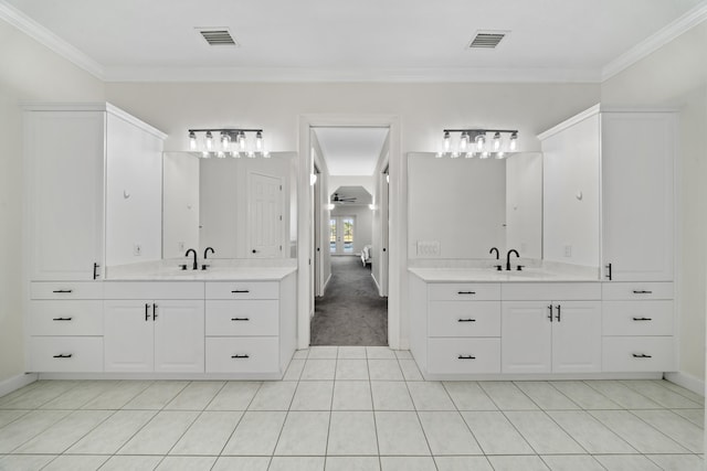 ensuite bathroom featuring visible vents, two vanities, ensuite bathroom, and crown molding