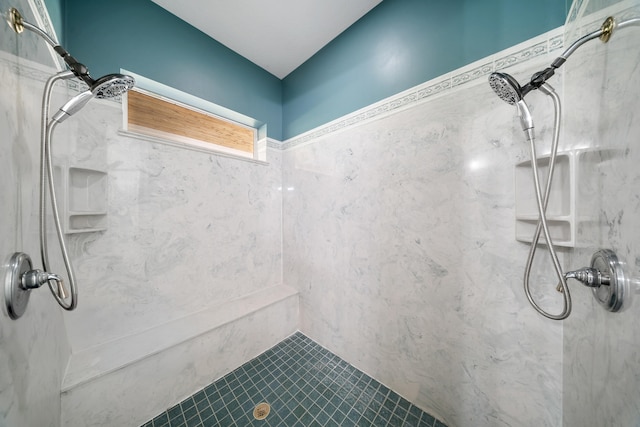 bathroom featuring a marble finish shower