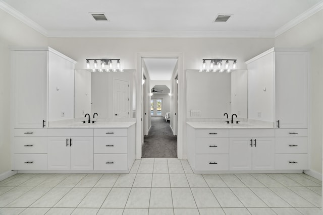 8686 Andrews Ave, Fort Pierce, FL 34945 - bathroom featuring two vanities, ornamental molding, tile patterned floors, connected bathroom, and baseboards