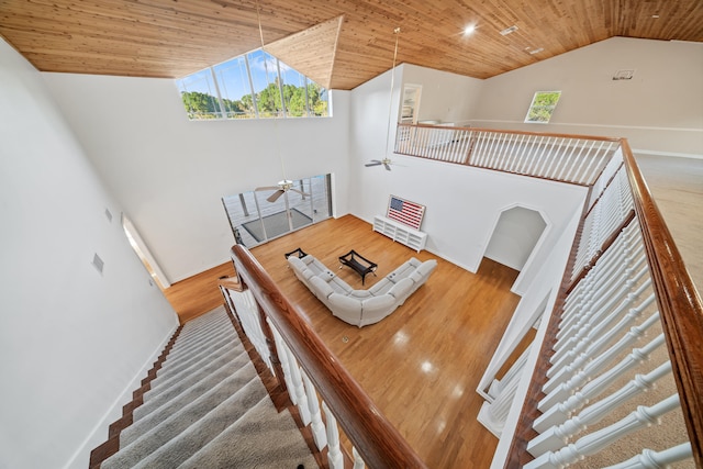 stairway featuring high vaulted ceiling, wood ceiling, wood finished floors, and a ceiling fan