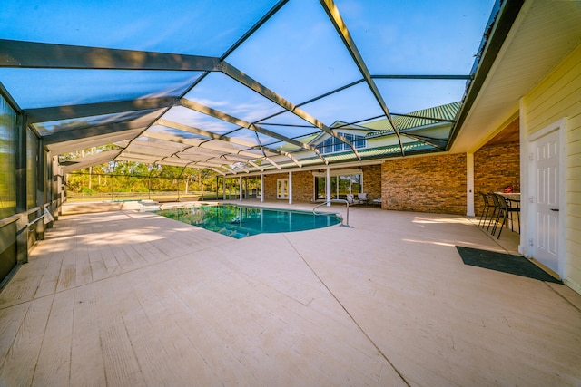 pool featuring a lanai and a patio area