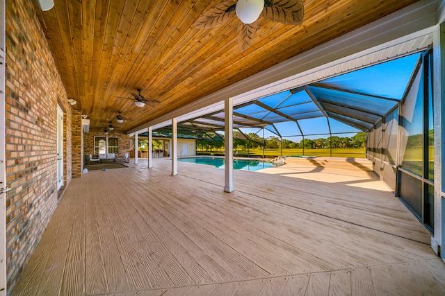 8686 Andrews Ave, Fort Pierce, FL 34945 - wooden deck with a ceiling fan, an outdoor pool, glass enclosure, and a patio