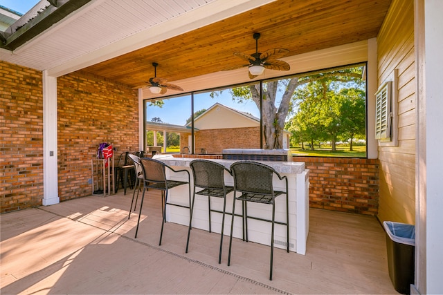 view of patio featuring outdoor wet bar and ceiling fan