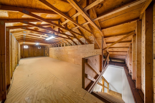 unfinished attic featuring an upstairs landing