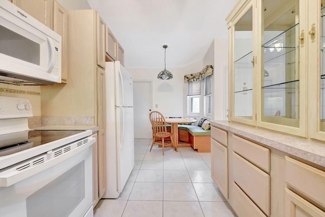 kitchen featuring white appliances, light tile patterned floors, hanging light fixtures, light countertops, and glass insert cabinets