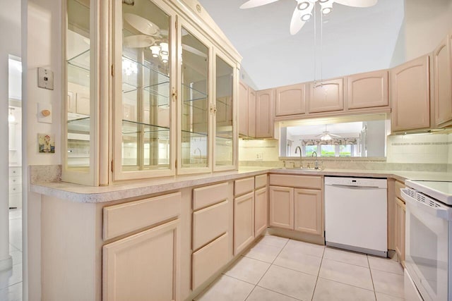 kitchen featuring light brown cabinetry, white appliances, a ceiling fan, and a sink