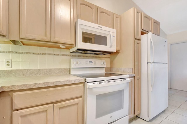 kitchen with light tile patterned flooring, backsplash, white appliances, and light countertops