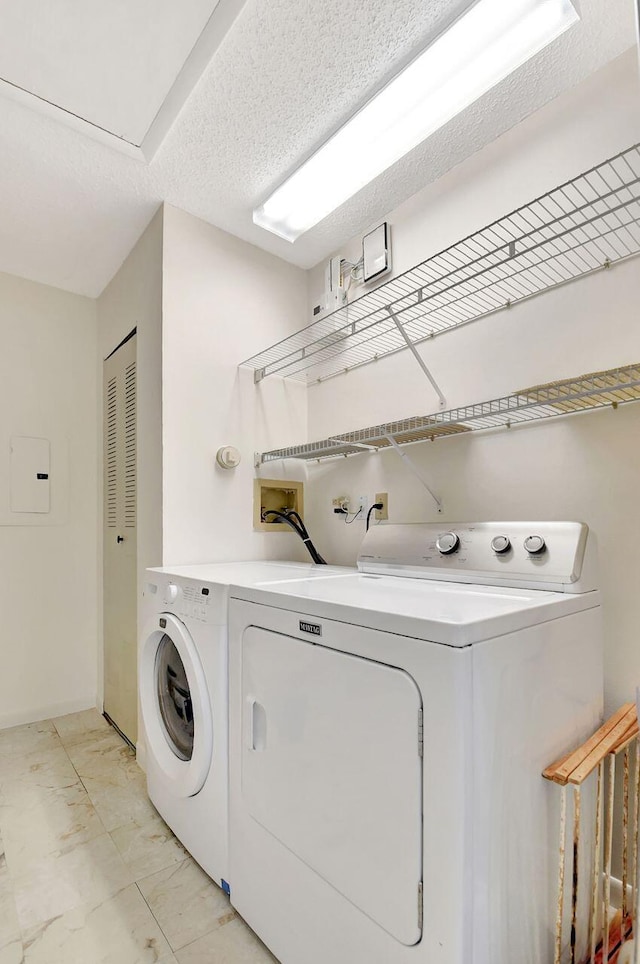 laundry area featuring marble finish floor, independent washer and dryer, laundry area, and a textured ceiling